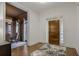 Inviting home foyer with hardwood floors, elegant front door, and adjacent dining area at 49 Conifer Park Ln, Atlanta, GA 30342