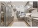 Open kitchen layout featuring a wine fridge, shaker cabinets, and direct view of the staircase at 49 Conifer Park Ln, Atlanta, GA 30342