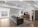 Modern living room with hardwood floors, gray sofa, entertainment center, and a stylish wet bar in background at 49 Conifer Park Ln, Atlanta, GA 30342