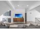 Large, well-lit living room featuring hardwood floors, recessed lighting, and a stylish entertainment center at 49 Conifer Park Ln, Atlanta, GA 30342