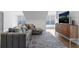 Spacious living room with a comfortable sectional sofa, patterned rug, and entertainment center with large TV at 49 Conifer Park Ln, Atlanta, GA 30342