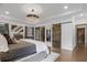 Bright main bedroom with tray ceiling, elegant lighting, and rustic sliding barn doors at 49 Conifer Park Ln, Atlanta, GA 30342
