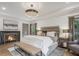 Elegant main bedroom with a fireplace, comfortable seating, and large windows at 49 Conifer Park Ln, Atlanta, GA 30342