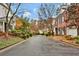 Charming street view of well-maintained homes with beautiful landscaping and mature trees, creating a welcoming neighborhood at 49 Conifer Park Ln, Atlanta, GA 30342