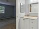 Bright bathroom with white vanity, neutral countertops, updated fixtures and natural light next to the bedroom at 511 Barrington Hills Dr, Atlanta, GA 30350
