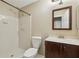 Bathroom with white tiled shower, wood vanity and modern fixtures at 511 Barrington Hills Dr, Atlanta, GA 30350