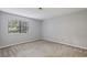 Cozy bedroom featuring large window and neutral carpet at 511 Barrington Hills Dr, Atlanta, GA 30350