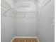 Walk-in closet featuring wall mounted metal shelving and neutral carpeting at 511 Barrington Hills Dr, Atlanta, GA 30350