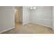 Neutral-toned dining room features modern baseboards, ample lighting, and access to a bathroom at 511 Barrington Hills Dr, Atlanta, GA 30350