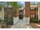 Apartment building exterior with a gated bridge, landscaping, and stairs to the apartments at 511 Barrington Hills Dr, Atlanta, GA 30350