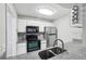 Well-equipped kitchen with stainless steel appliances, granite counters, white cabinets, and modern backsplash at 511 Barrington Hills Dr, Atlanta, GA 30350
