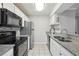 Modern kitchen with stainless steel appliances, granite countertops, and white cabinetry offering lots of counter space at 511 Barrington Hills Dr, Atlanta, GA 30350
