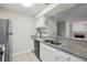 Traditional kitchen featuring granite countertops and white cabinetry at 511 Barrington Hills Dr, Atlanta, GA 30350