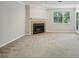 Comfortable living room featuring a cozy fireplace, lots of natural light, and a neutral color scheme at 511 Barrington Hills Dr, Atlanta, GA 30350