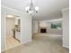 Bright living room with a fireplace, light gray walls, large windows, and access to the kitchen at 511 Barrington Hills Dr, Atlanta, GA 30350