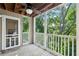 Enclosed porch overlooking wooded backyard with ceiling fan and door to the house at 511 Barrington Hills Dr, Atlanta, GA 30350