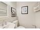 Clean powder room with a white sink, framed mirror and decorative art at 1105 Clairemont Ave # J, Decatur, GA 30030