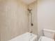 Bathroom features a shower over tub, tiled walls, and contemporary fixtures at 1105 Clairemont Ave # J, Decatur, GA 30030