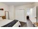 Bedroom with dark wood floors, white closet doors and a mirror at 1105 Clairemont Ave # J, Decatur, GA 30030
