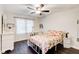 Cozy bedroom with hardwood floors, ceiling fan, and a bright, floral-themed decor at 1105 Clairemont Ave # J, Decatur, GA 30030