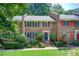 Charming brick townhouse with blue shutters, landscaped yard, and inviting entrance at 1105 Clairemont Ave # J, Decatur, GA 30030