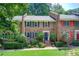 Charming brick townhome featuring colorful shutters and a beautifully landscaped front yard at 1105 Clairemont Ave # J, Decatur, GA 30030