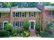 Charming brick townhome with blue shutters and professionally landscaped front yard at 1105 Clairemont Ave # J, Decatur, GA 30030