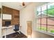 A well-lit home office with a large window, stylish accents, and modern desk at 1105 Clairemont Ave # J, Decatur, GA 30030