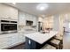 Modern kitchen with white cabinets, stainless steel appliances, and island with seating at 1105 Clairemont Ave # J, Decatur, GA 30030