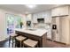 Updated kitchen with white cabinets, stainless steel appliances, and island with barstools at 1105 Clairemont Ave # J, Decatur, GA 30030