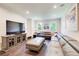 Bright living room featuring hardwood floors, a large sectional sofa and large TV at 1105 Clairemont Ave # J, Decatur, GA 30030