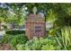 View of a brick street marker surrounded by greenery and trees in a residential neighborhood at 1105 Clairemont Ave # J, Decatur, GA 30030