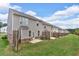 Backyard view of townhomes featuring patios, privacy fences, and well-maintained lawns on a sunny day at 1311 Park Center Cir, Austell, GA 30168