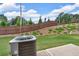 Green backyard with air conditioner, fence, and trees in the background at 1311 Park Center Cir, Austell, GA 30168