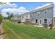 Exterior backyard view of townhomes, each with a patio and lawn, offering a private outdoor space at 1311 Park Center Cir, Austell, GA 30168