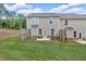 Spacious backyard with a wooden fence, grassy lawn, and patio at 1311 Park Center Cir, Austell, GA 30168