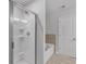 Modern bathroom features a glass-enclosed shower and soaking tub at 1311 Park Center Cir, Austell, GA 30168