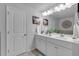 Bright bathroom featuring double sinks, a large mirror, and elegant white cabinetry for ample storage at 1311 Park Center Cir, Austell, GA 30168
