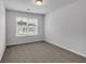 Bright bedroom featuring neutral walls, plush carpet, and a window offering abundant natural light at 1311 Park Center Cir, Austell, GA 30168