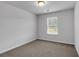 Cozy bedroom space featuring neutral tones and one window which provides ample natural lighting at 1311 Park Center Cir, Austell, GA 30168