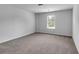Spacious bedroom with soft carpet, a window, and neutral color scheme at 1311 Park Center Cir, Austell, GA 30168