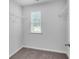 Spacious walk-in closet with carpeted floors, shelving, and a window providing natural light at 1311 Park Center Cir, Austell, GA 30168