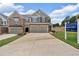 View of a two-story townhome with two-car garage near a sales center at 1311 Park Center Cir, Austell, GA 30168