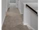 Carpeted hallway with a staircase, neutral color scheme at 1311 Park Center Cir, Austell, GA 30168
