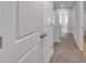 Hallway with carpeted floors and white trim, leading to other rooms in the home at 1311 Park Center Cir, Austell, GA 30168