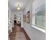Hallway with wood-look floors, decorated with framed photos and lots of natural light at 1311 Park Center Cir, Austell, GA 30168