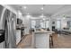 Modern kitchen with stainless steel appliances, granite counters, seating island, and access to living area at 1311 Park Center Cir, Austell, GA 30168
