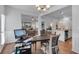 Bright home office space with wood flooring and open floor plan flowing into kitchen and living spaces at 1311 Park Center Cir, Austell, GA 30168