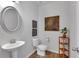 Stylish half bathroom showcases a modern vanity sink, wood-look flooring, and tasteful decorations at 1311 Park Center Cir, Austell, GA 30168