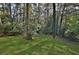 Expansive backyard features lush green grass and mature trees, offering plenty of space at 1770 Austin Dr, Decatur, GA 30032